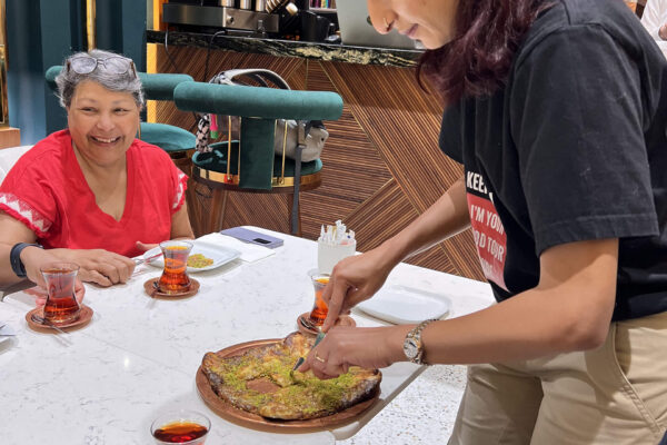 Guide serving Turkish Katmer - Dubai Mall Food Tour 1 (1) Guide serving Turkish Katmer - Dubai Mall Food Tour 1 (1)
