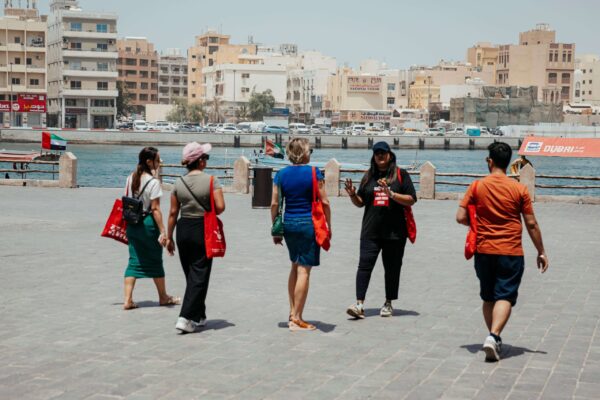 Guide talking about the historic Dubai Creek - Dubai Souks and Creekside Food Walk